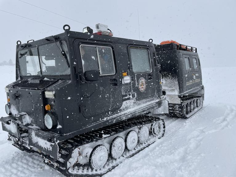 The snowcat in snow being driven for training